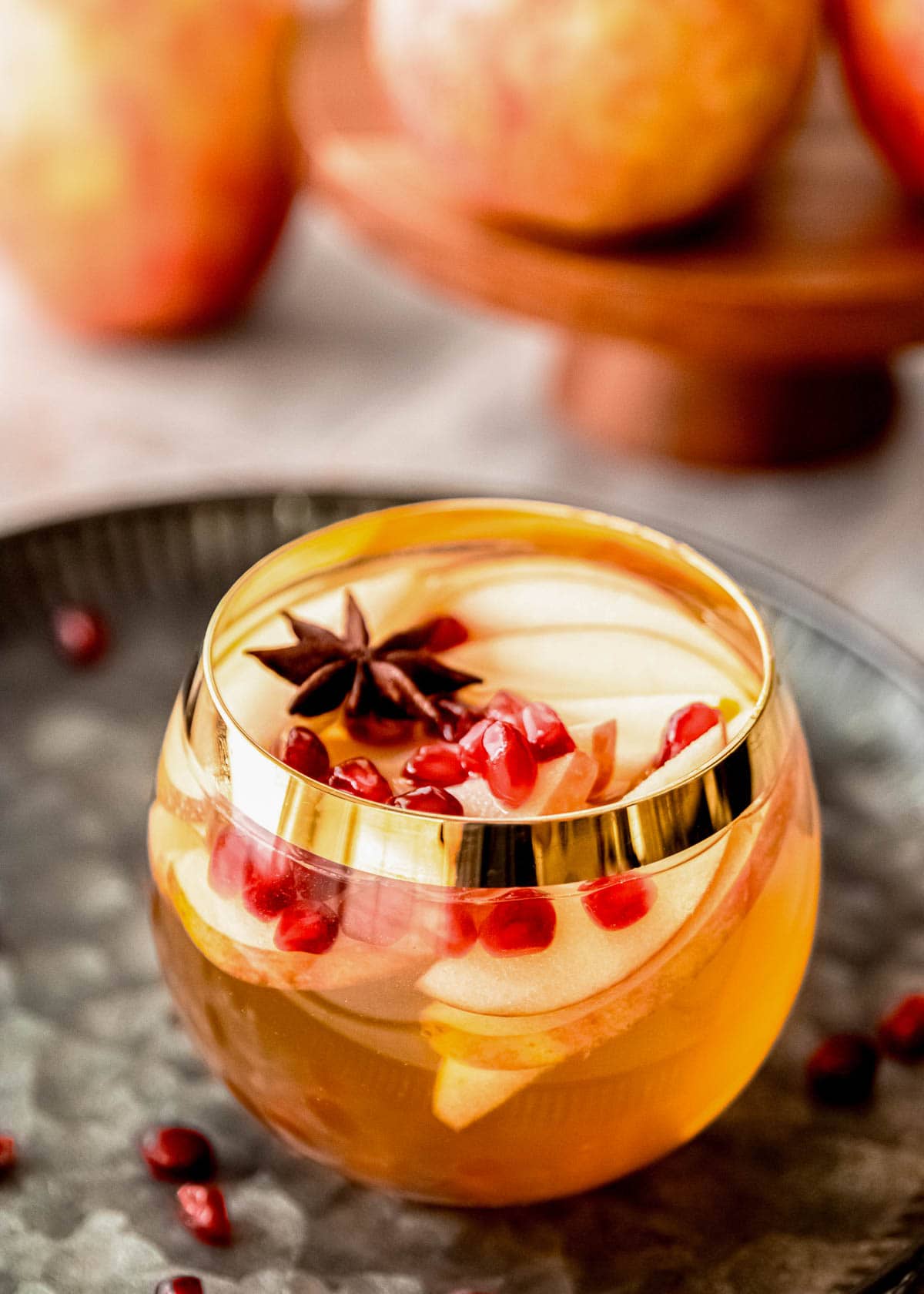 glass full of apple cider sangria with fruit inside
