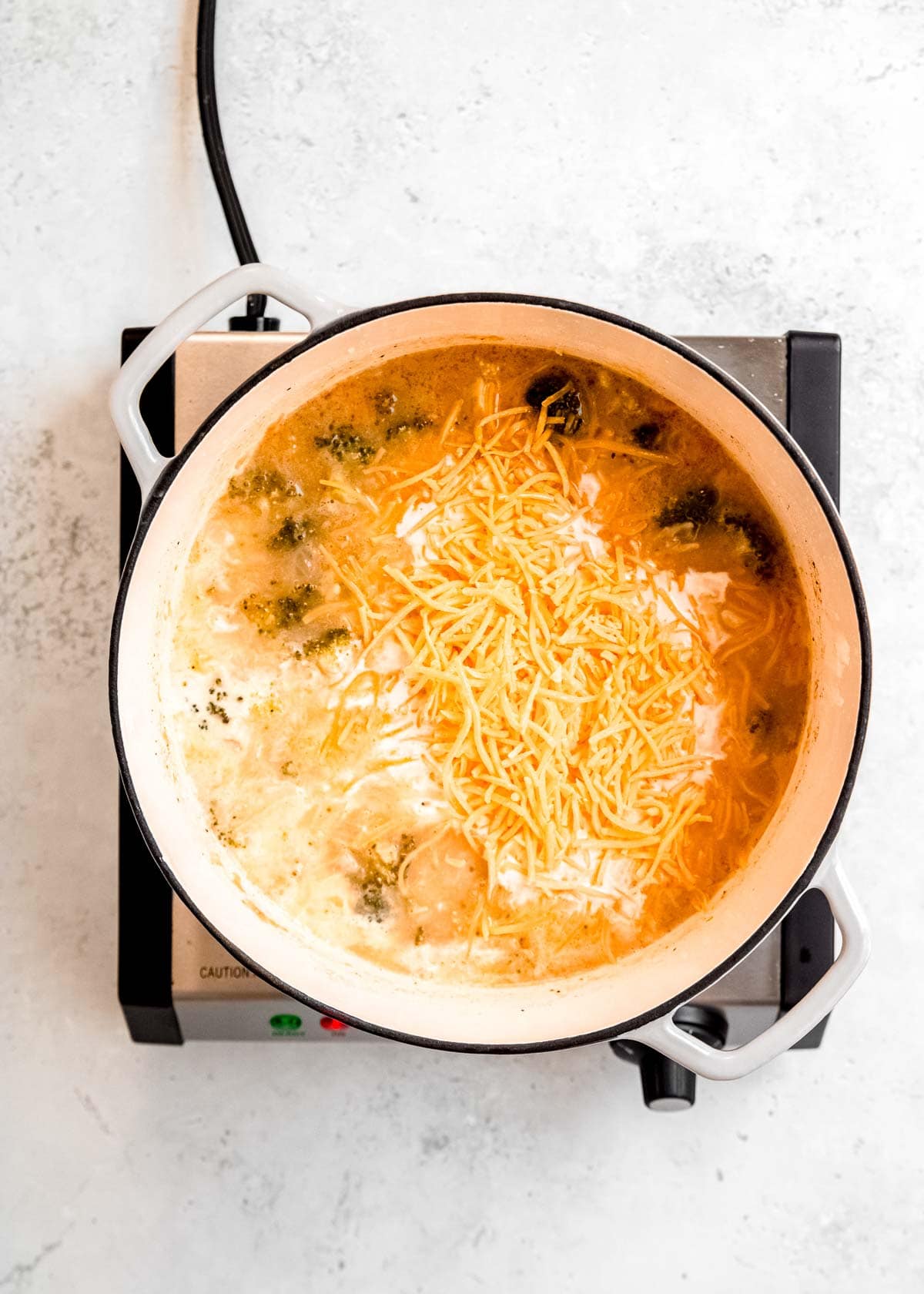 shredded cheddar in a dutch oven