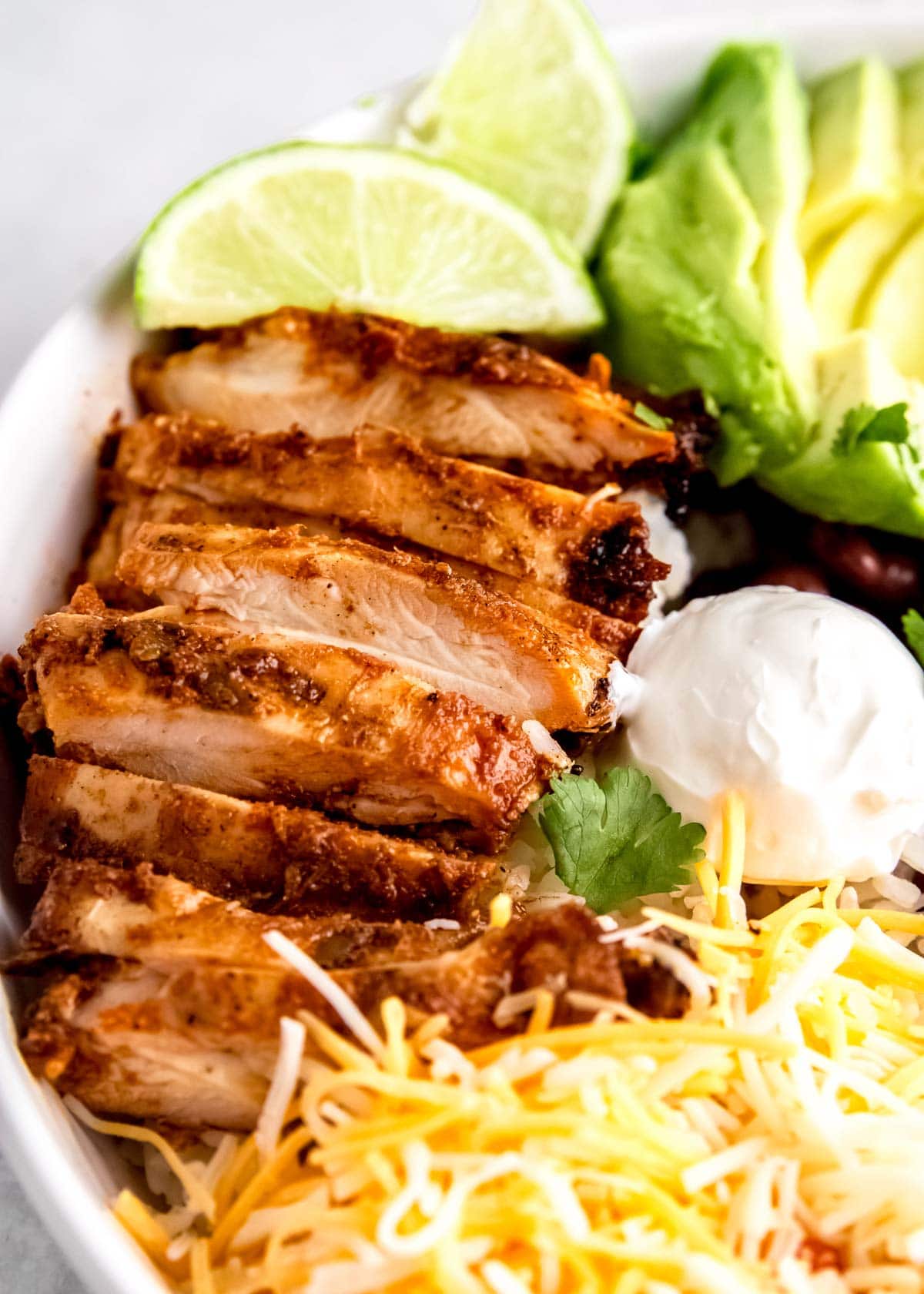 chicken burrito bowl ingredients on a white plate