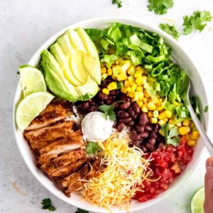 chicken burrito bowl ingredients on a white plate