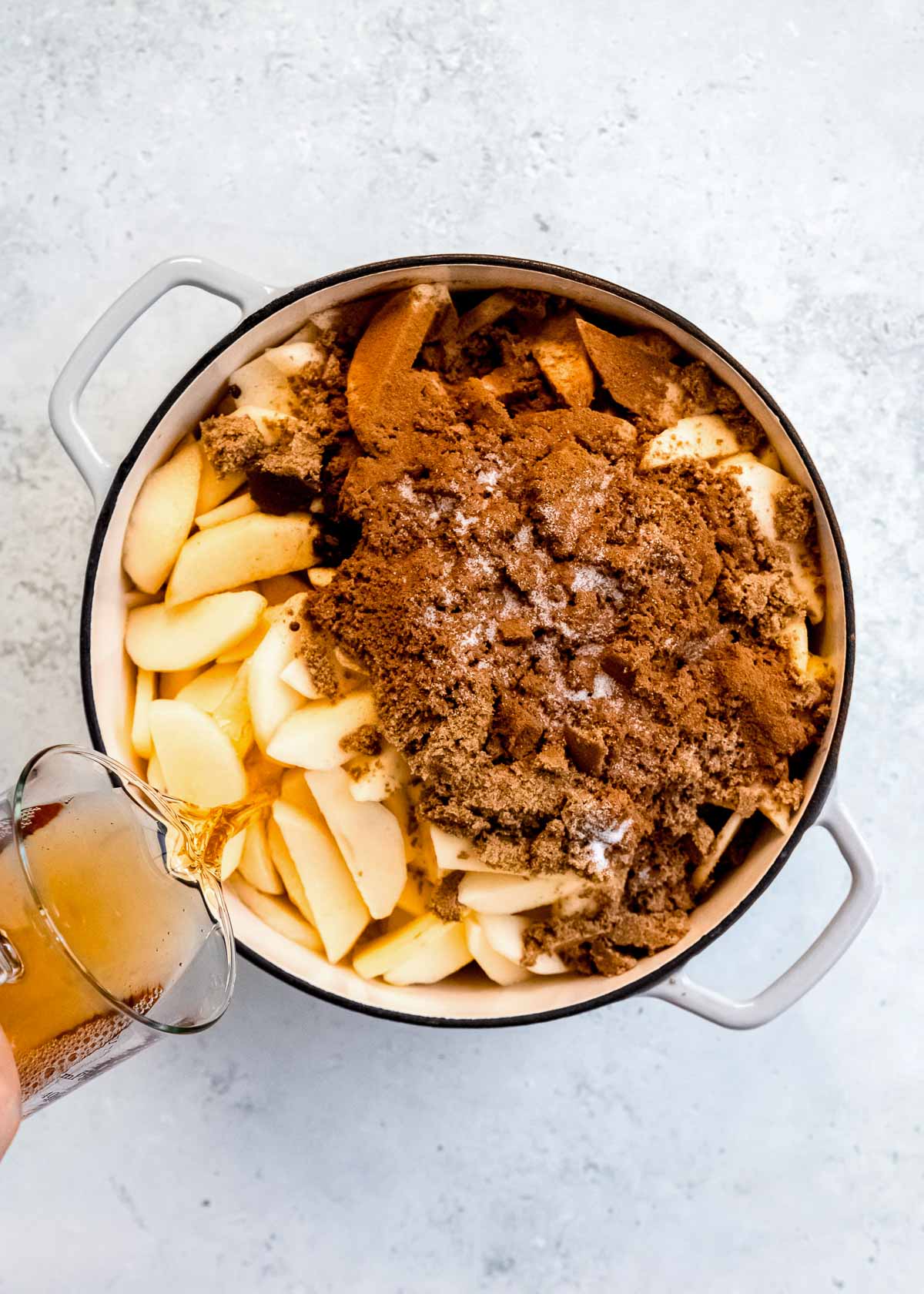 sliced apples in dutch oven with brown sugar