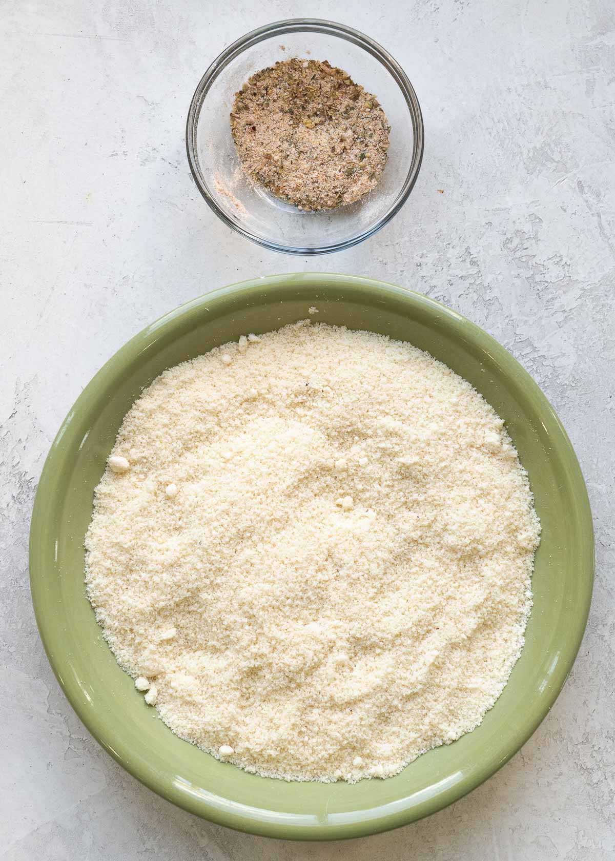 almond flour and parmesan in a shallow dish with all seasonings mixed in a small bowl