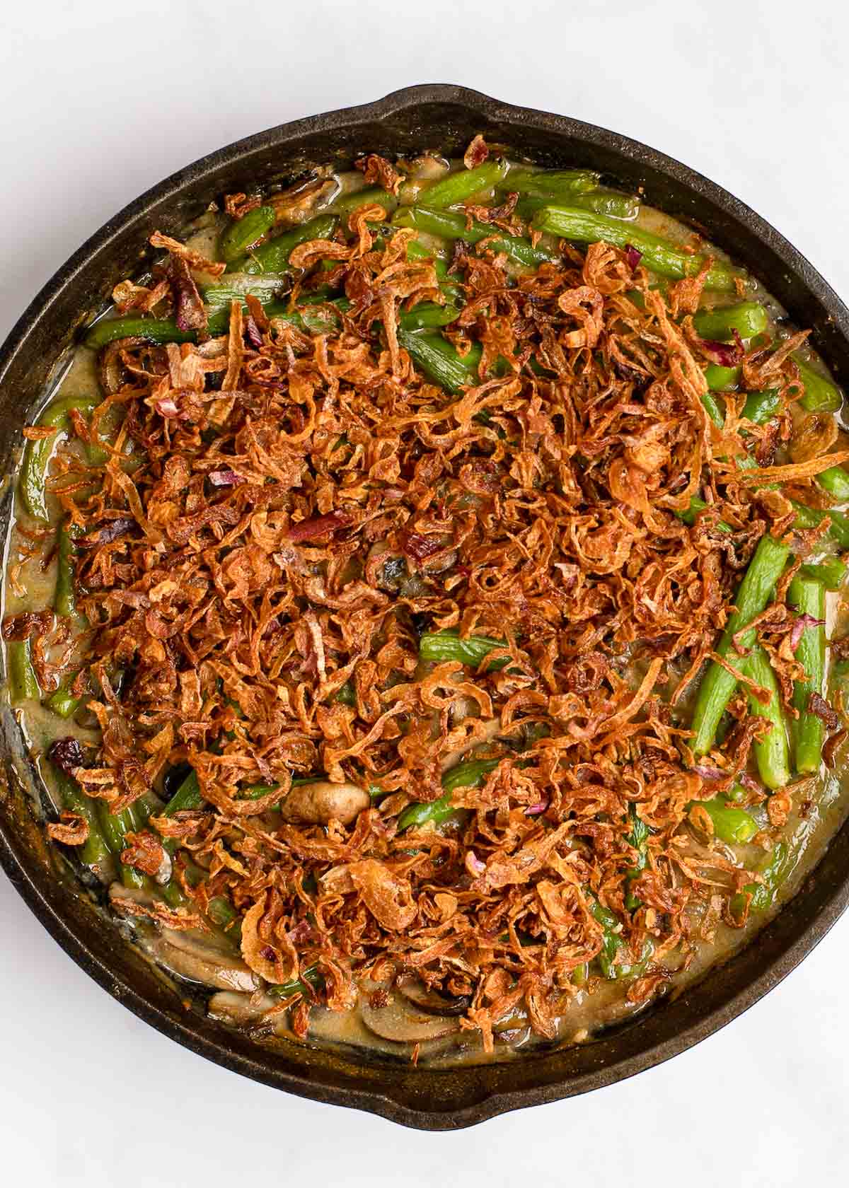 green bean casserole with fried onions in skillet