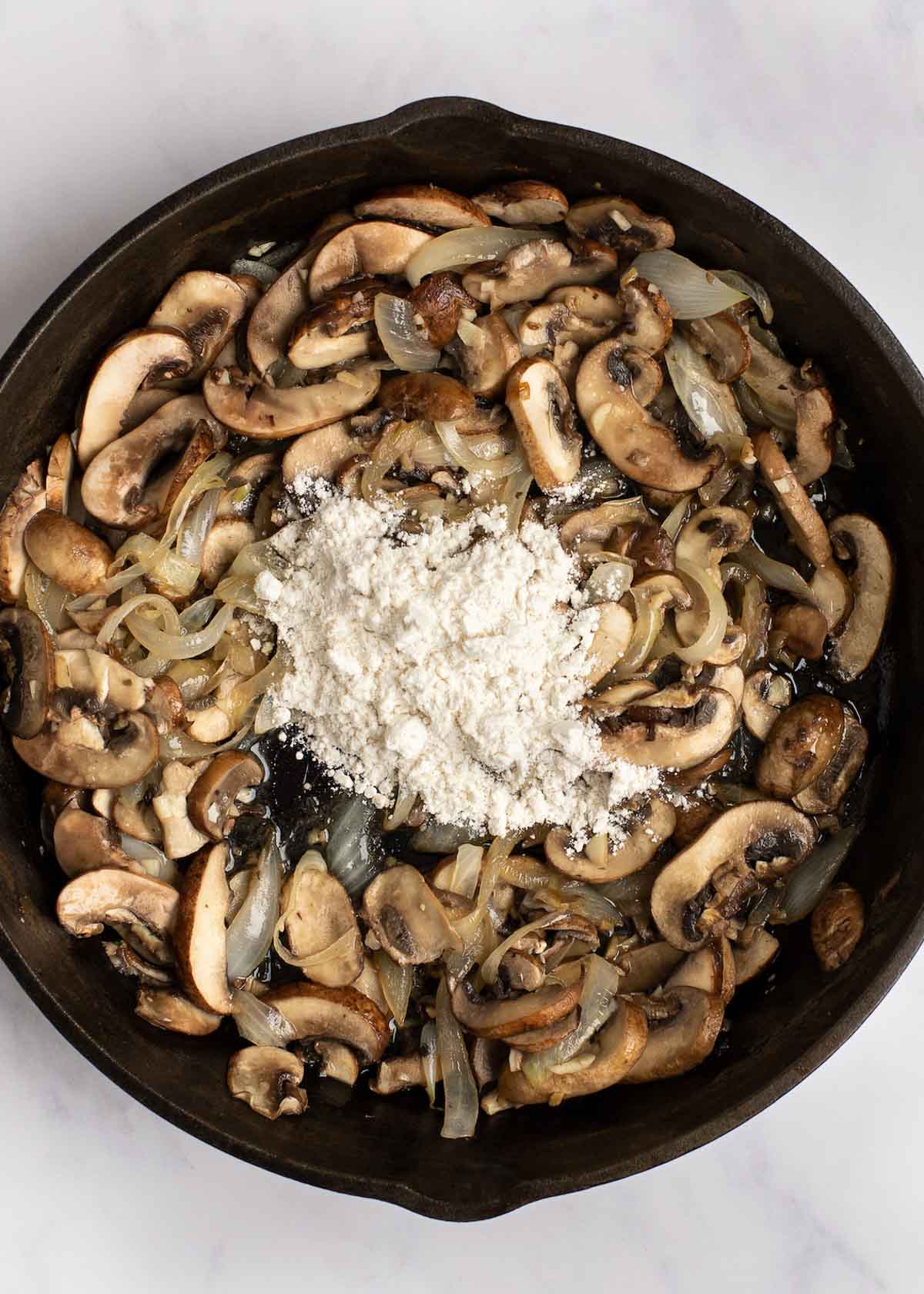 mushrooms in skillet with gluten free flour