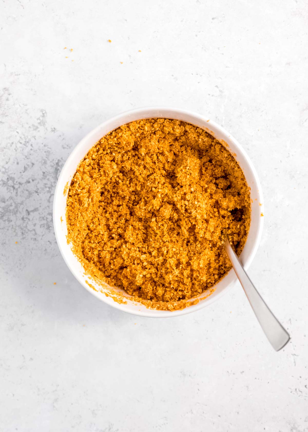 graham cracker cheesecake crust in a white bowl