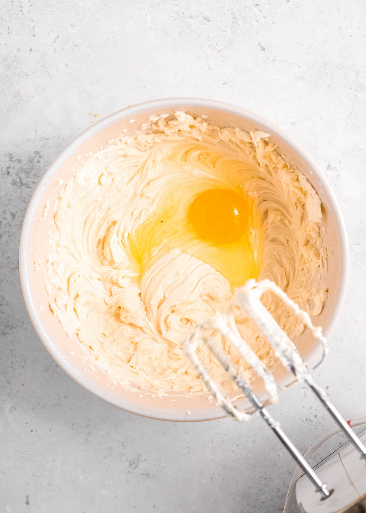 beaten cheesecake mixture with egg