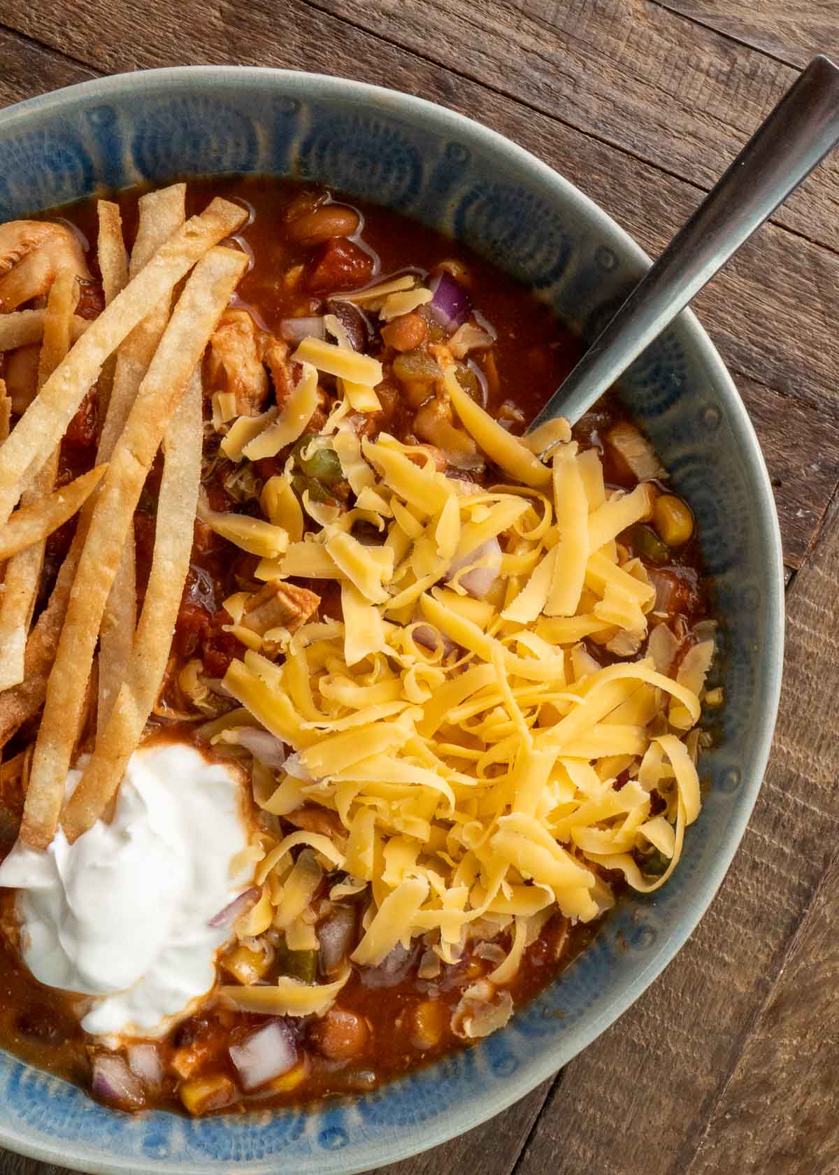 chicken tortilla soup in a blue bowl