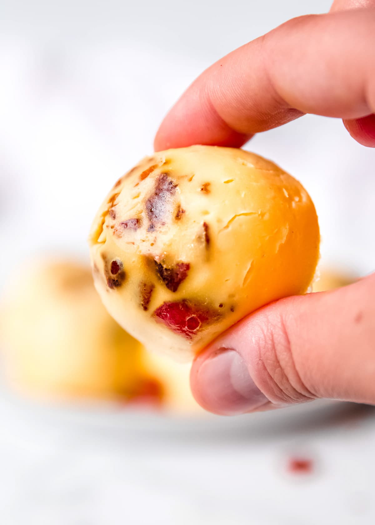 closeup shot of a hand holding an egg bite