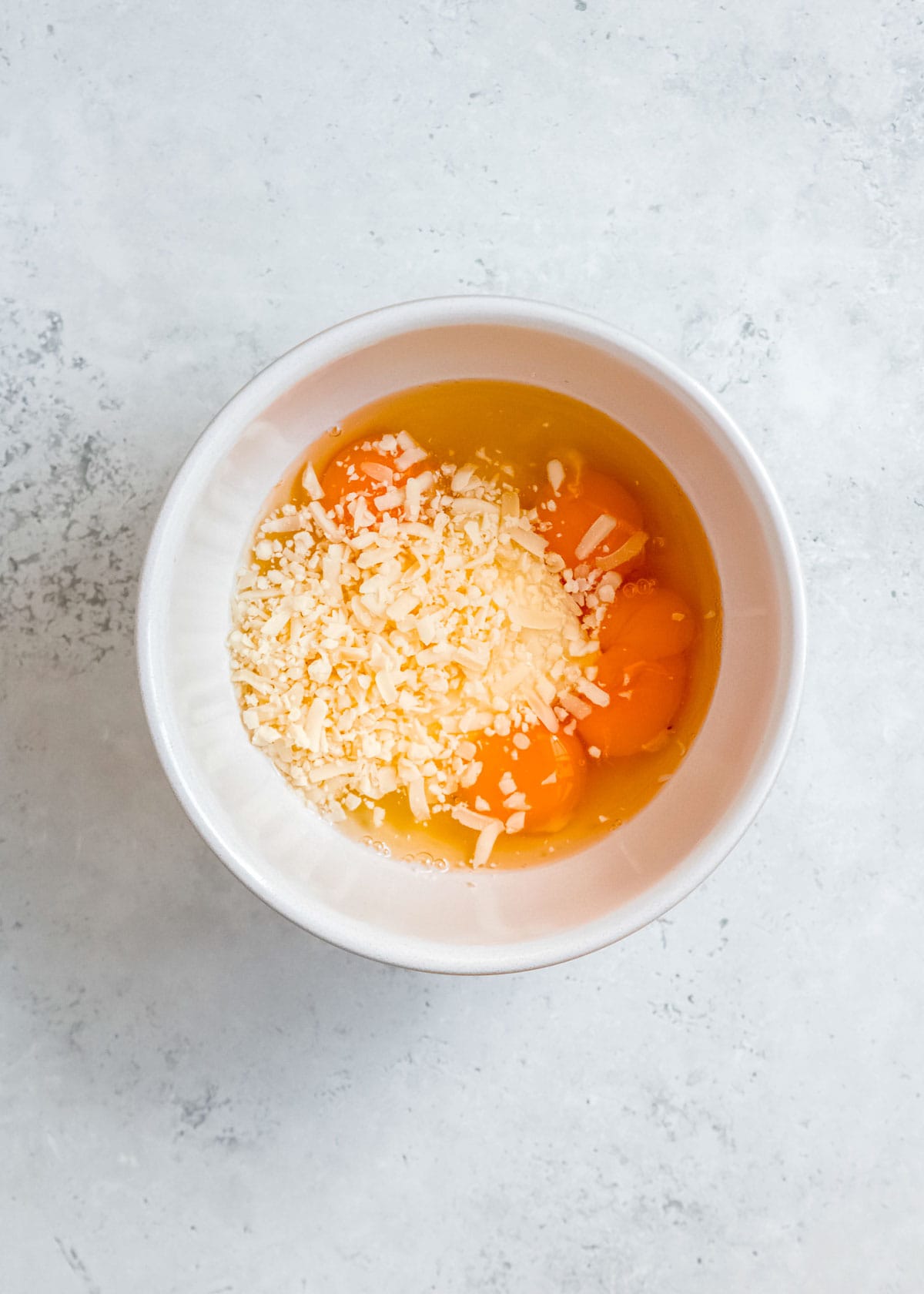 melted cream cheese in a bowl with eggs and cheese