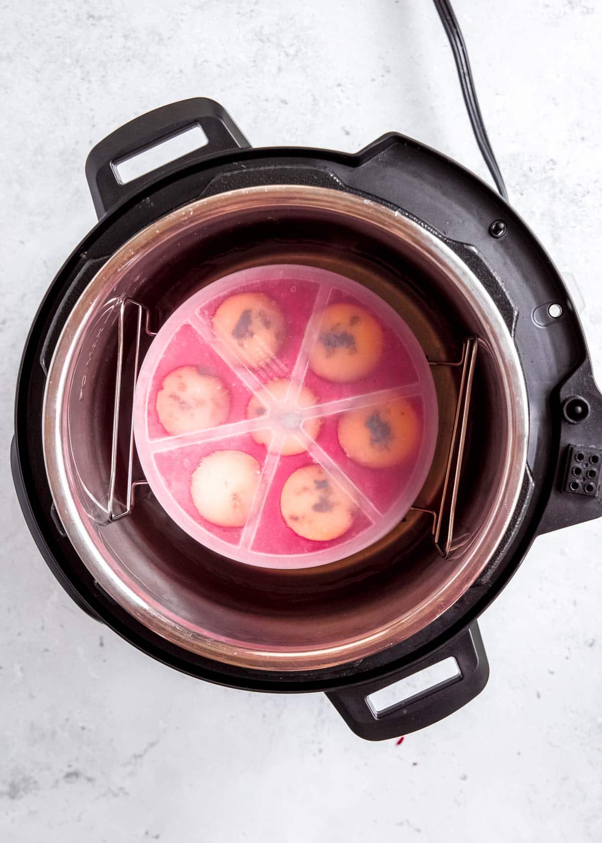 egg bite mold filled with a lid on in an instant pot