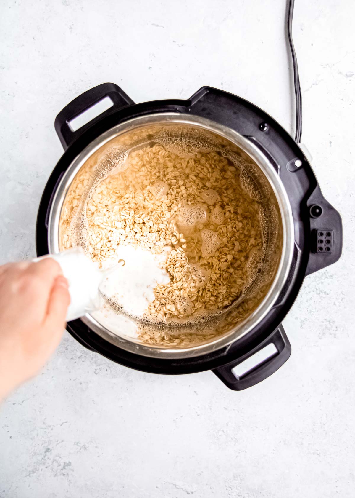 oatmeal ingredients being added to instant pot