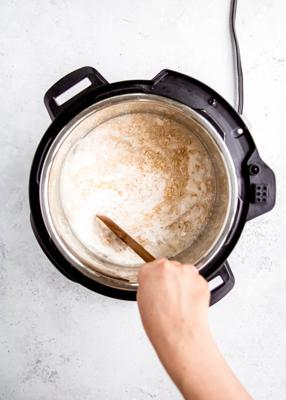 oatmeal ingredients being stirred in instant pot 