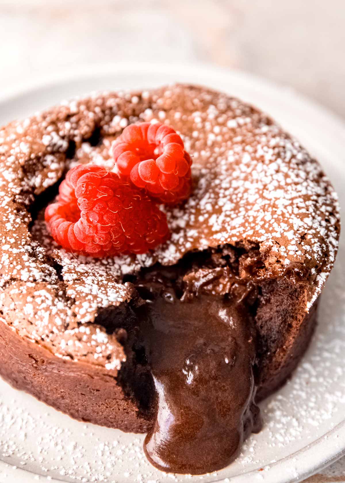 closeup of chocolate lava spilling out of molten chocolate cake