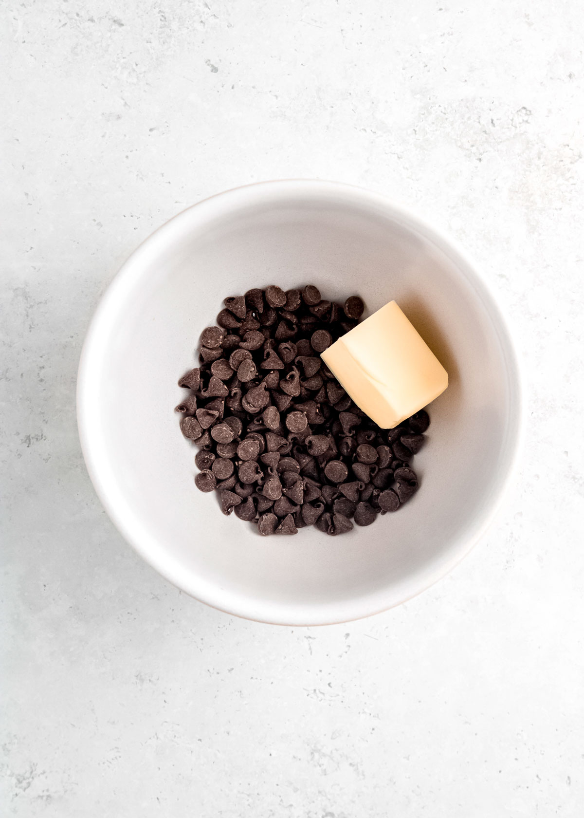 chocolate chips and butter in a white bowl