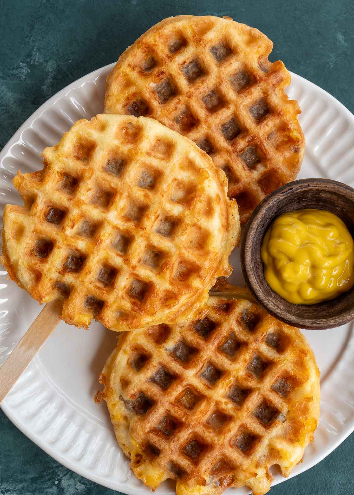 These Sausage Stuffed Chaffles feature crispy, cheesy waffles stuffed with a perfectly cooked sausage patty! Each chaffle contains less than 2 net carbs and requires just 5 simple ingredients!