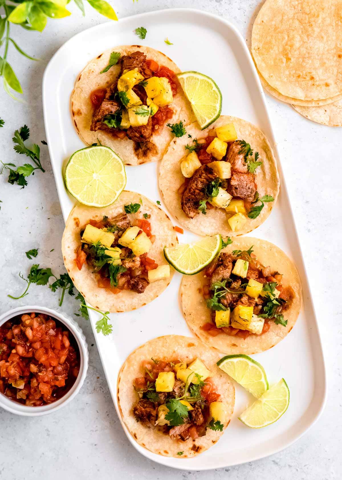 tacos al pastor on white platter