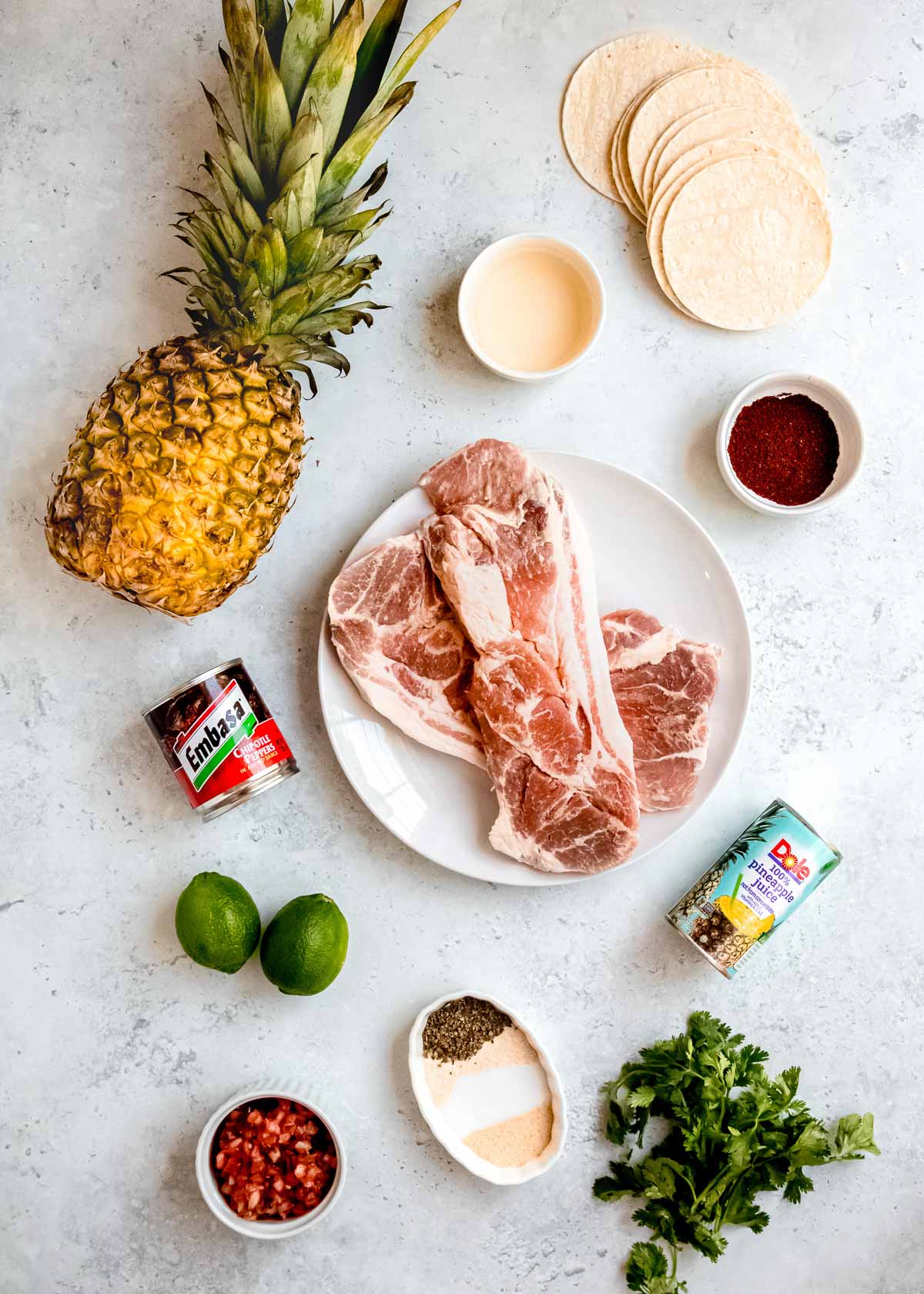 tacos al pastor ingredients on a white table