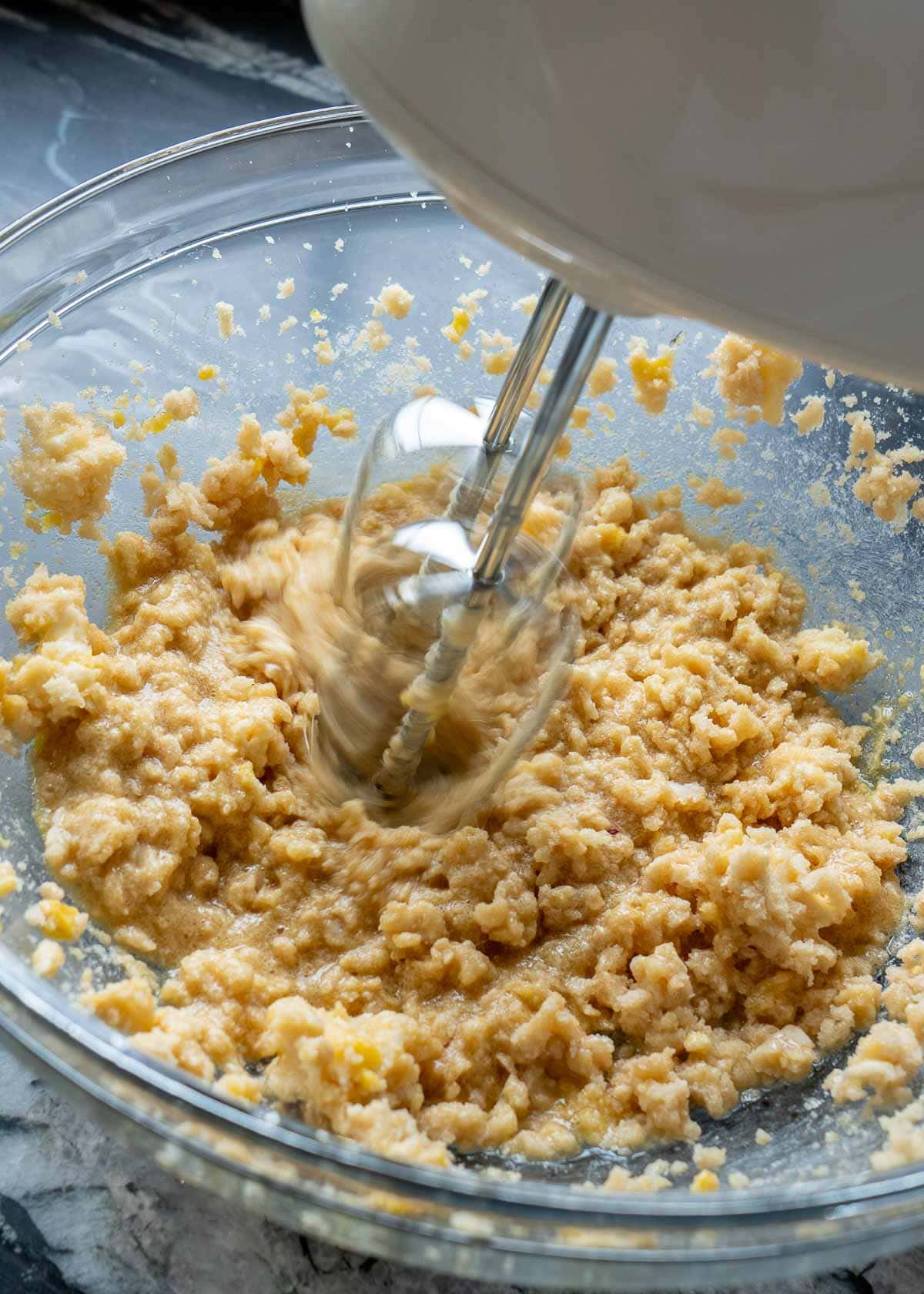 mixer beating egg into creamed butter and monk fruit