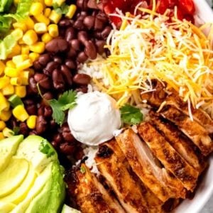 chicken burrito bowl ingredients on a white plate