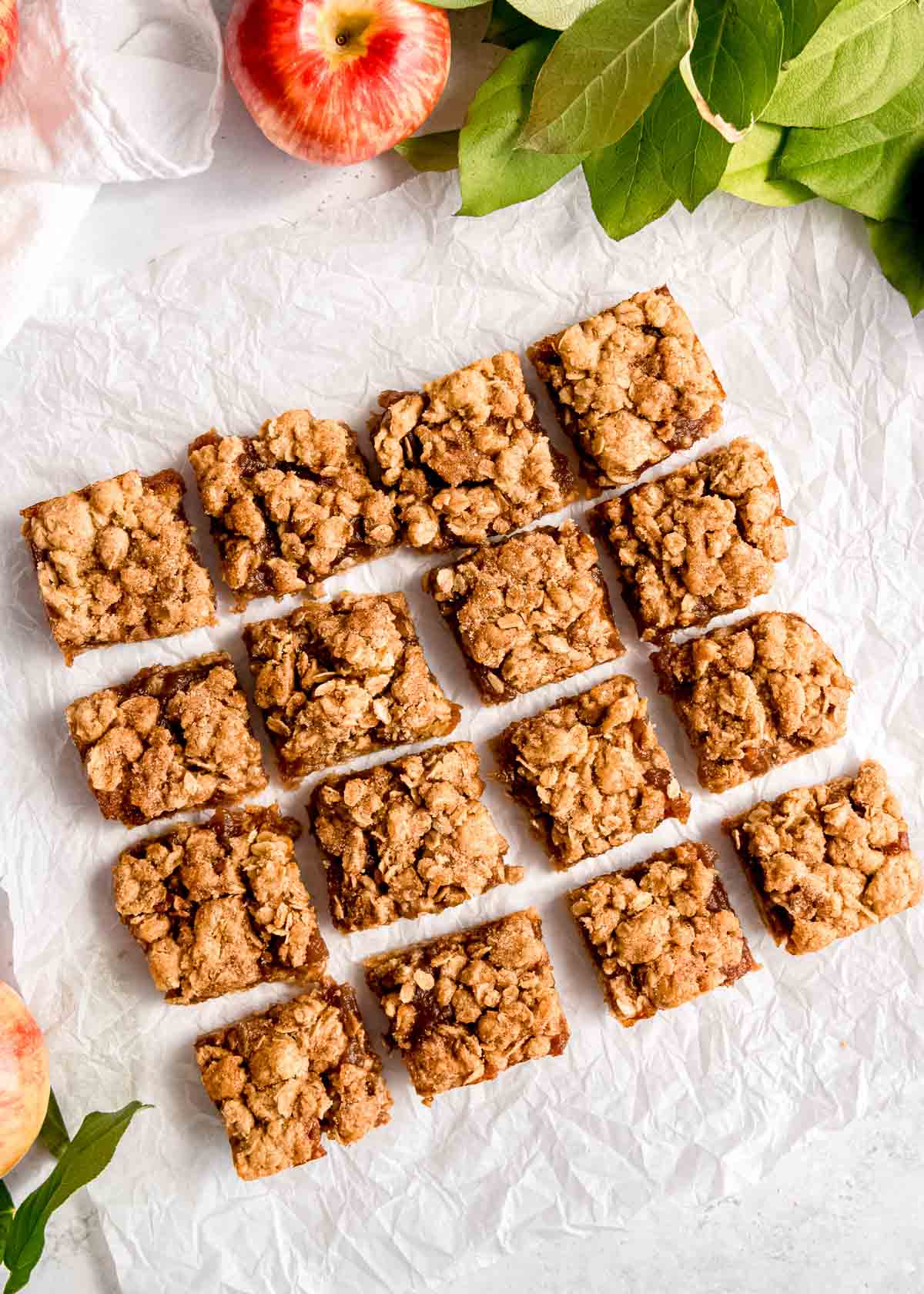 sliced apple crumble bars on parchment paper