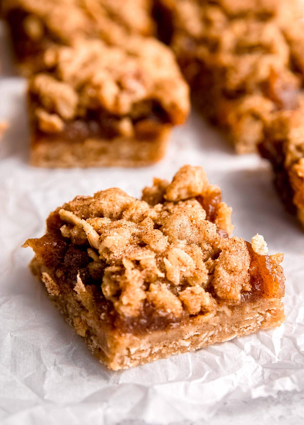 sliced apple butter bars on parchment paper