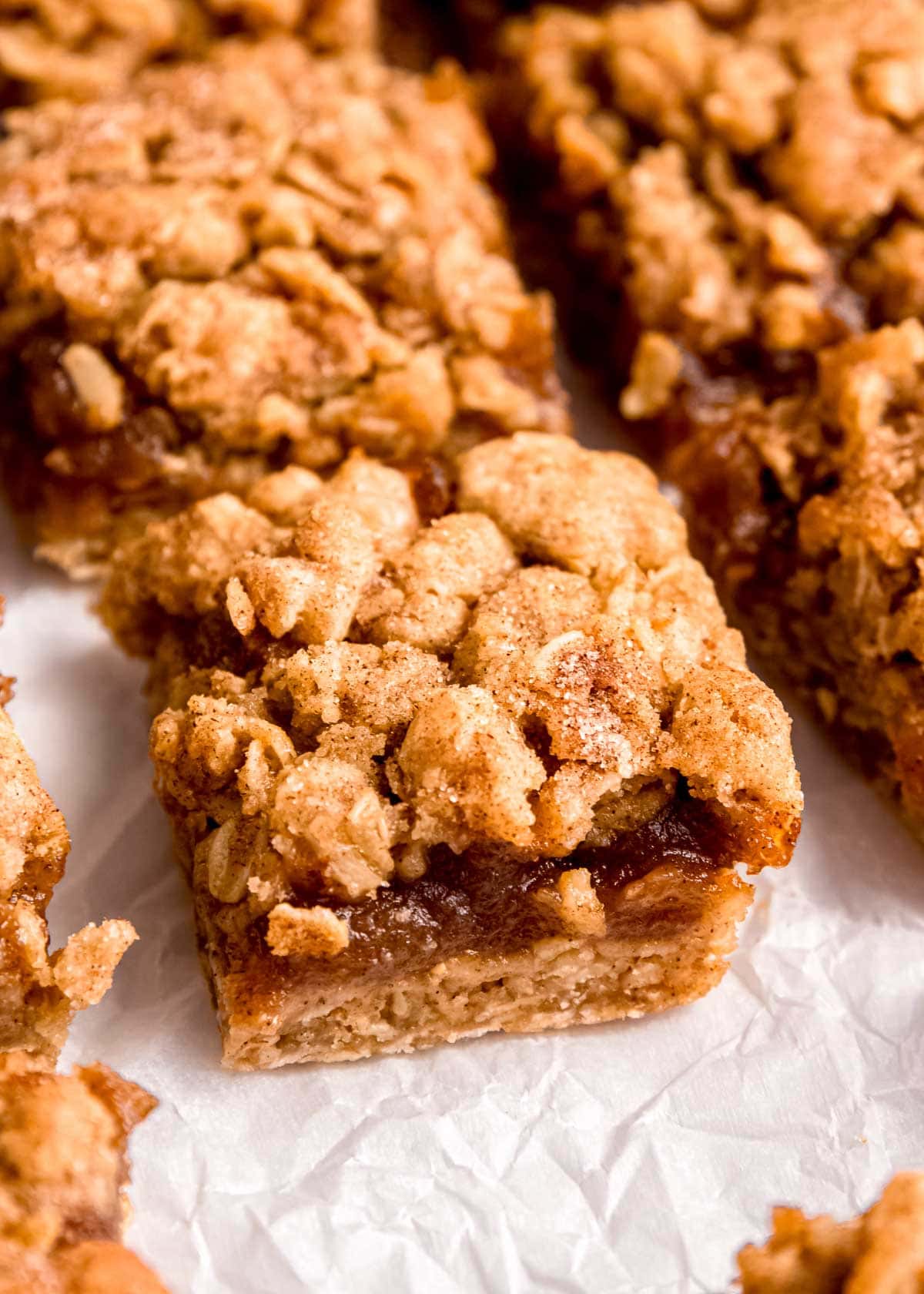 sliced apple butter bars on parchment paper