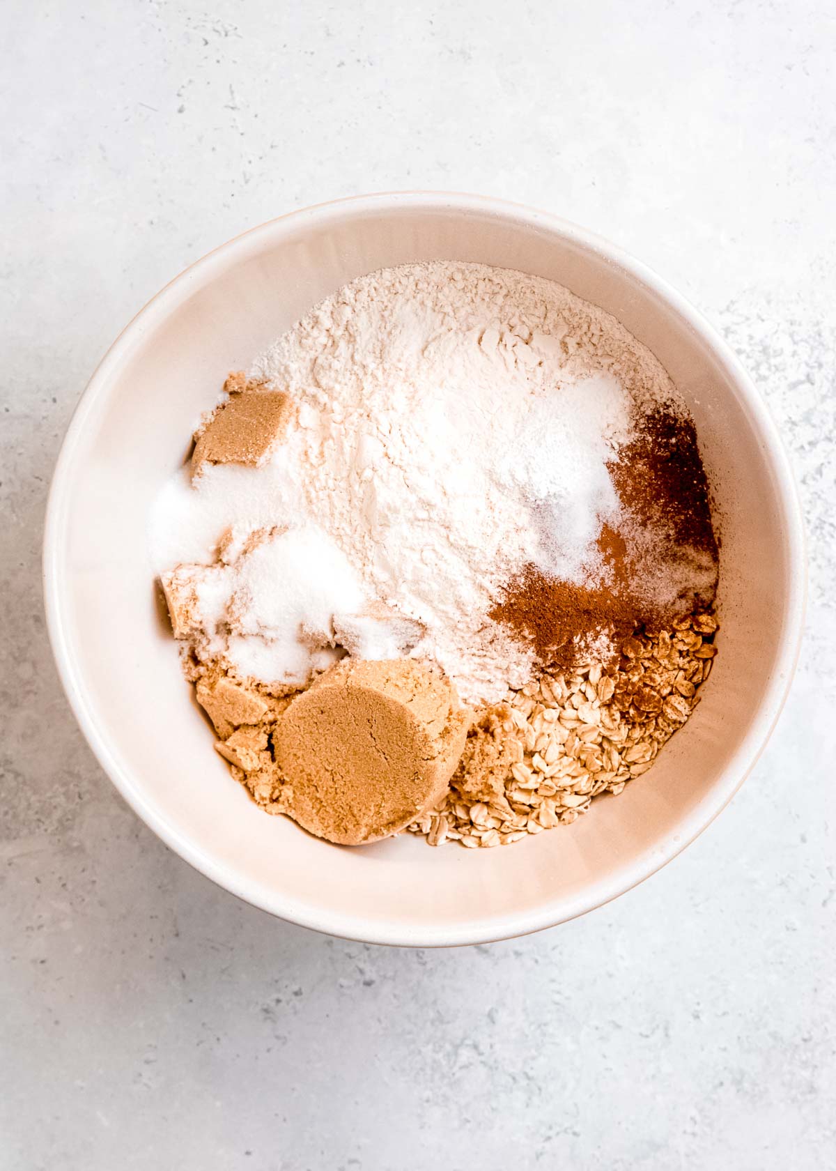 flour, oats, cinnamon, brown sugar, granulated sugar, and baking powder in a bowl