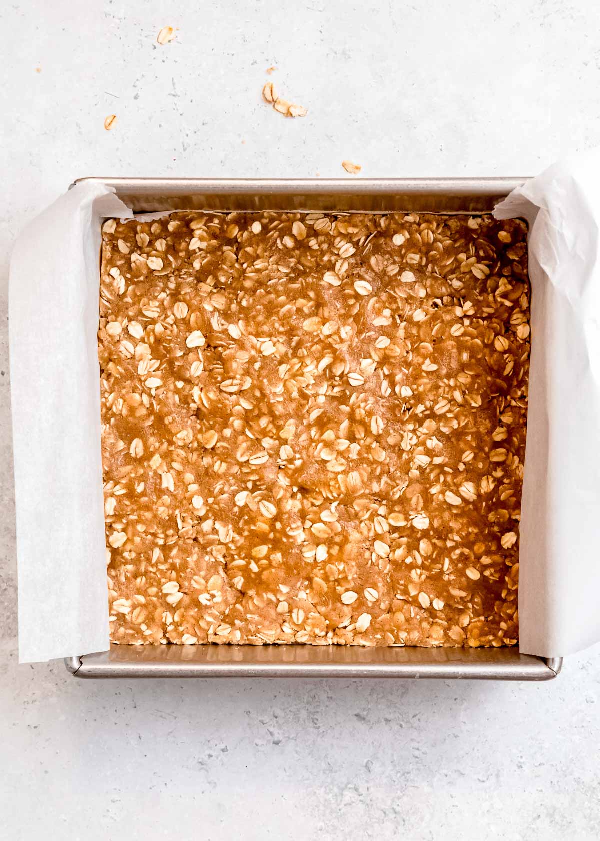 crust pressed into lined baking pan for apple butter bars