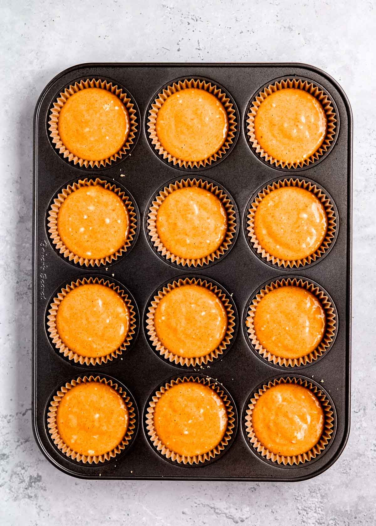 mini cheesecakes in a muffin tin