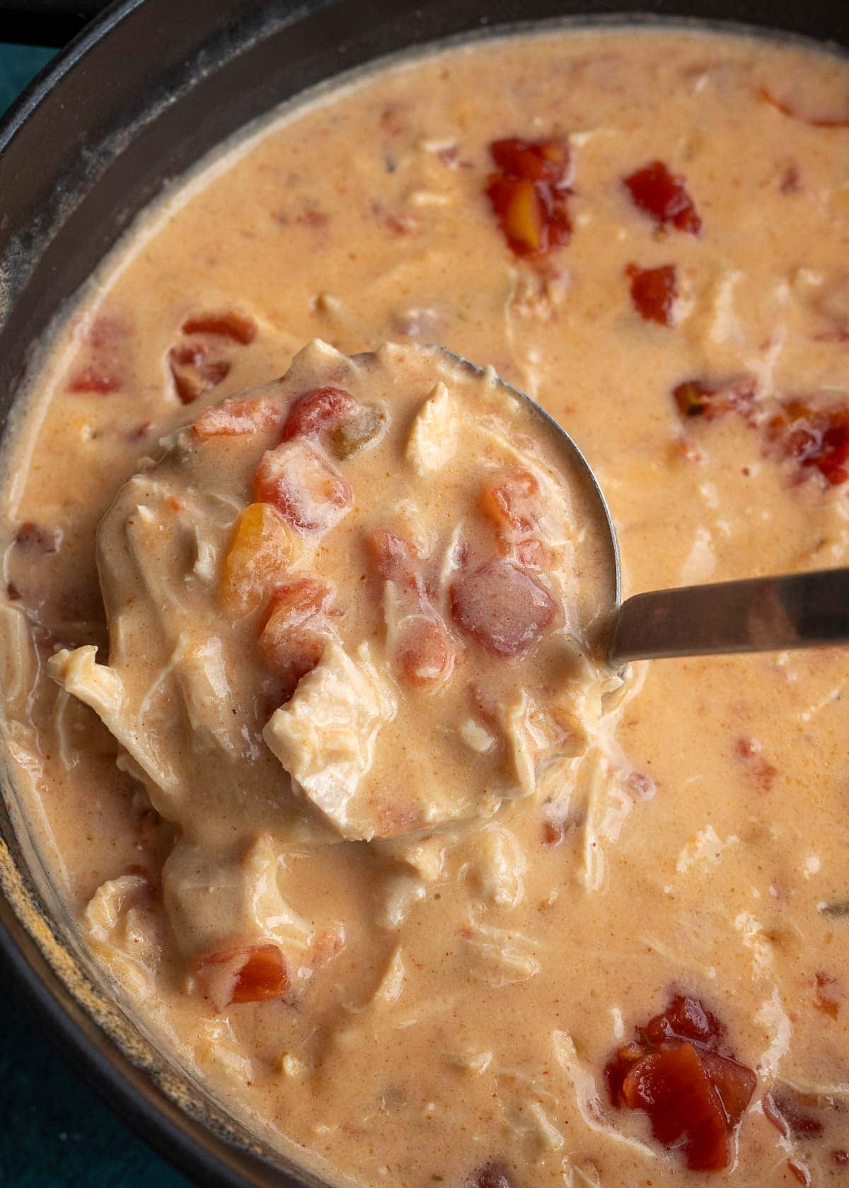 creamy cheesy rotel chicken soup in a ladle