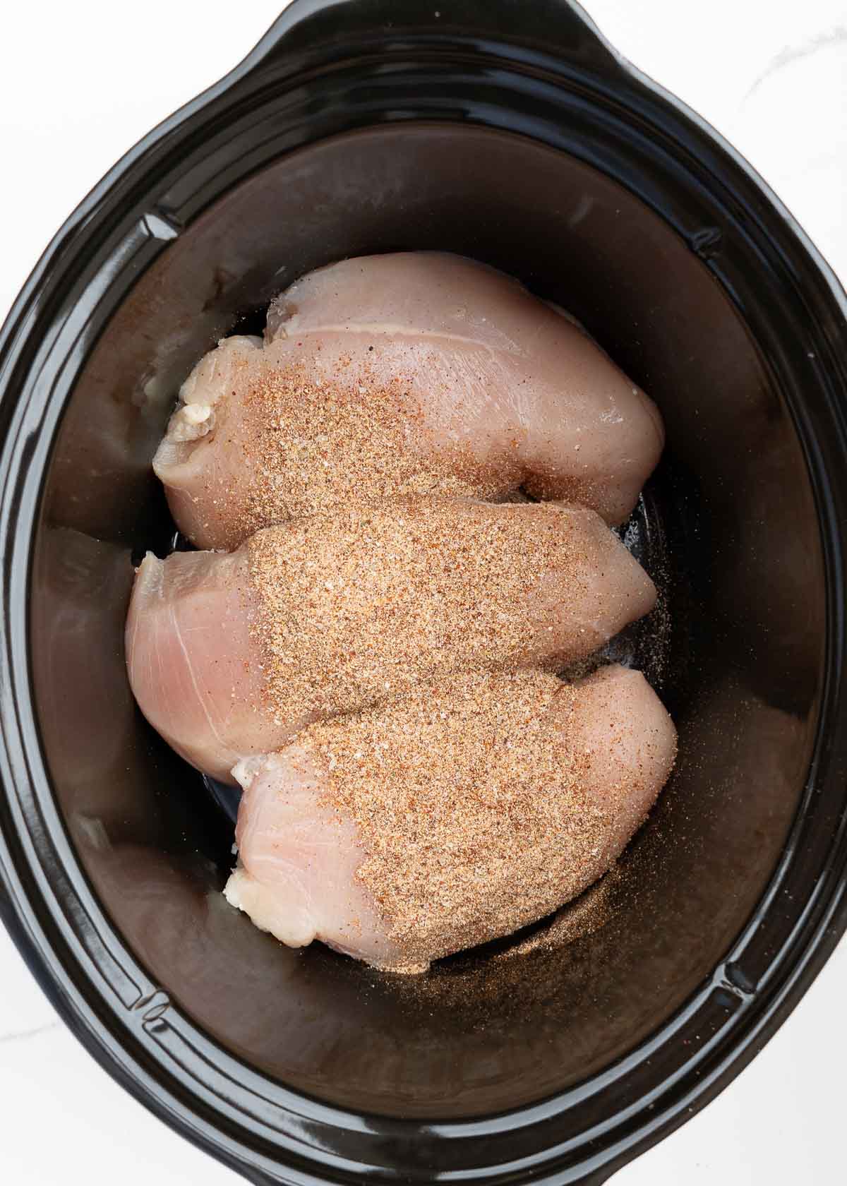 chicken and spices in slow cooker