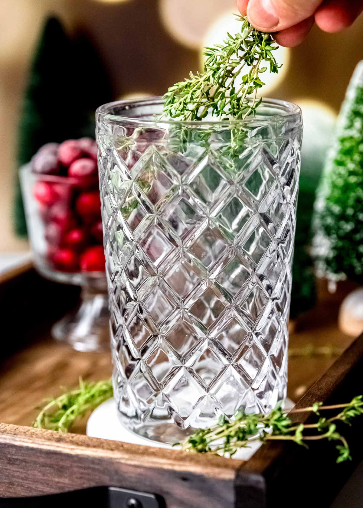 thyme and simple syrup in a glass