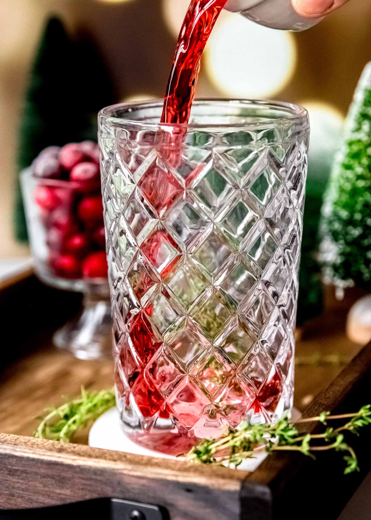 cranberry juice being added to glass