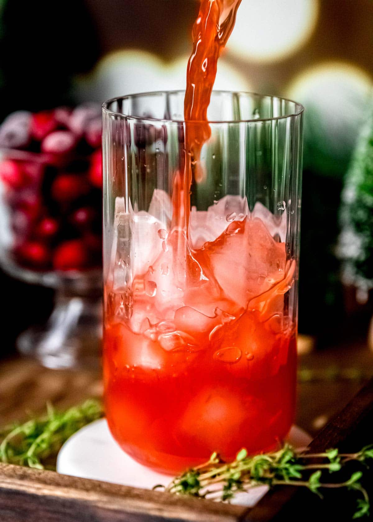 pouring strained cocktail over ice