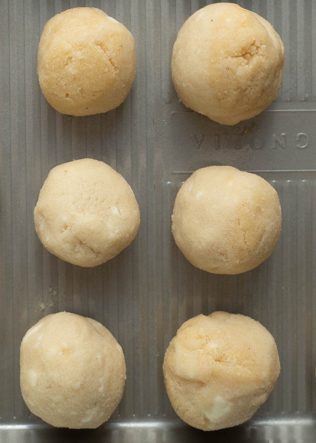 1 inch cookie dough balls on a baking sheet
