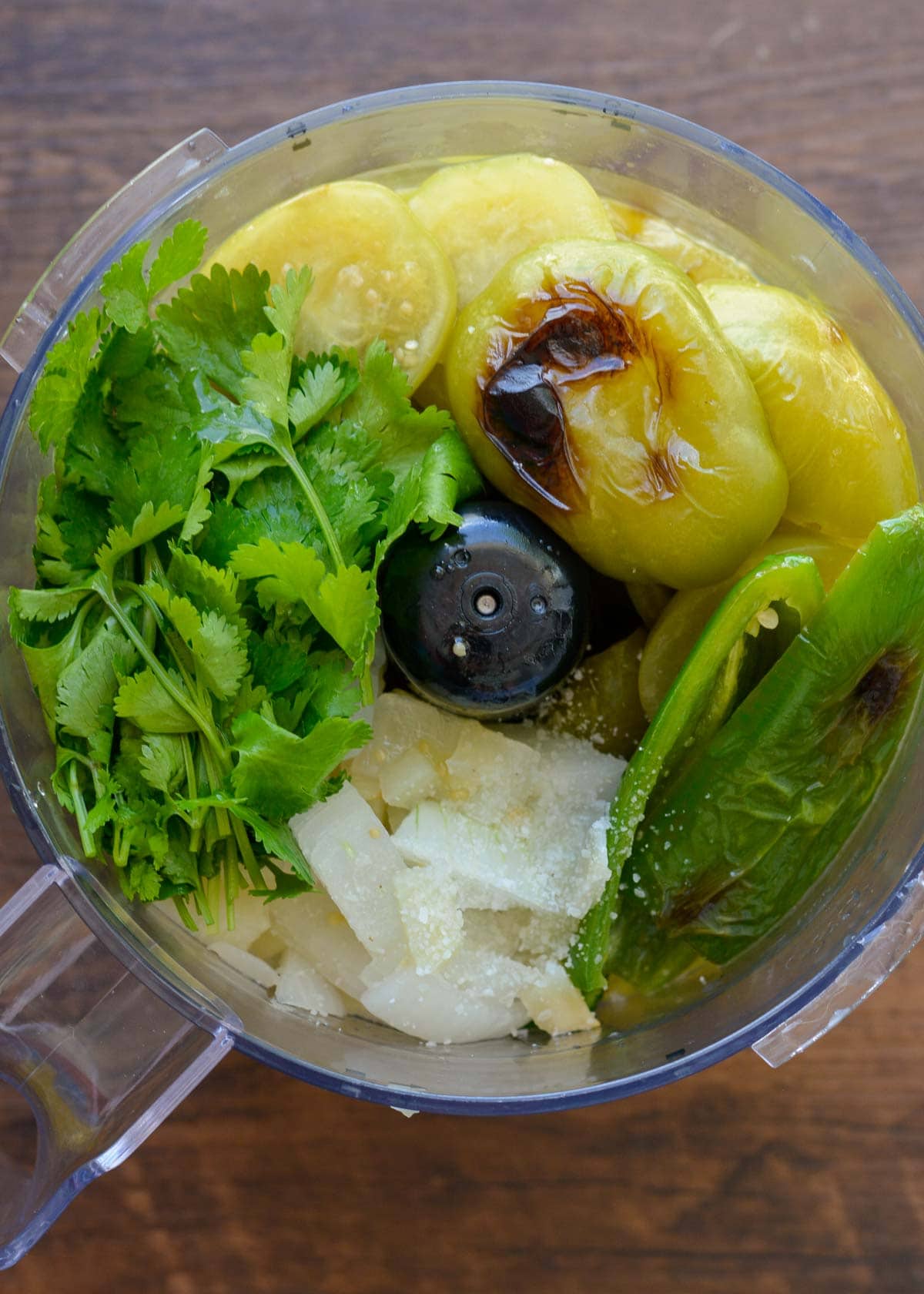 roasted tomatillos, jalapeno, onion, and herbs in a blender