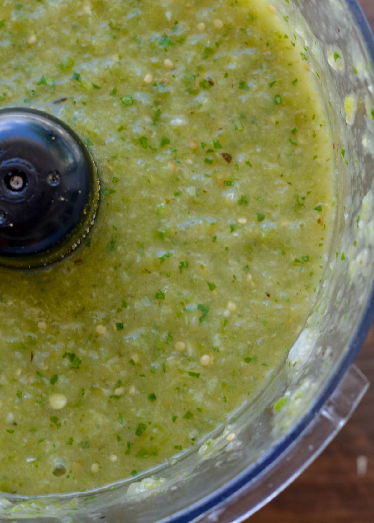 tomatillo salsa in a food processor, closeup shot