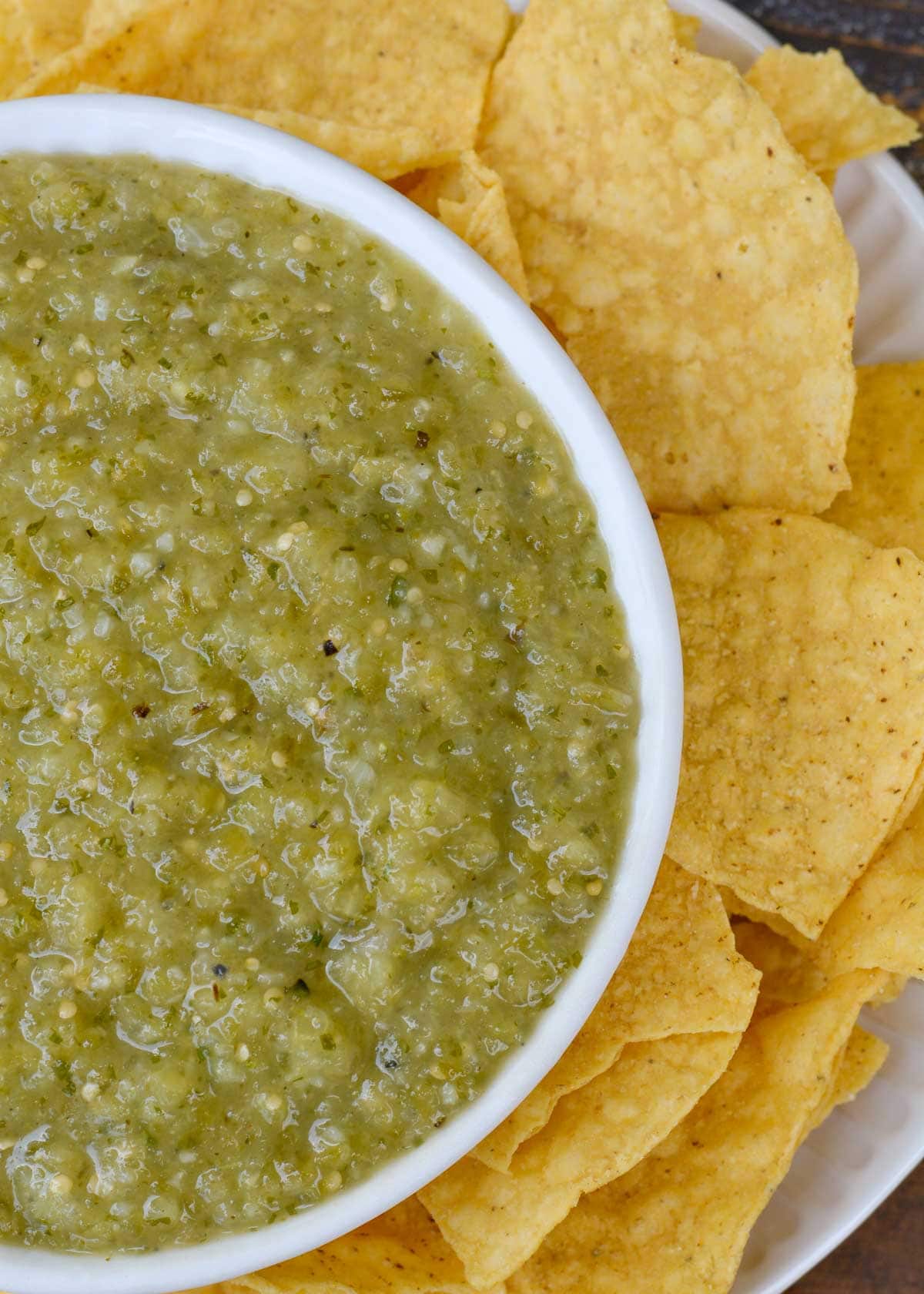 tomatillo salsa in a bowl surrounded by tortilla chips