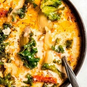 tuscan chicken soup in a black bowl