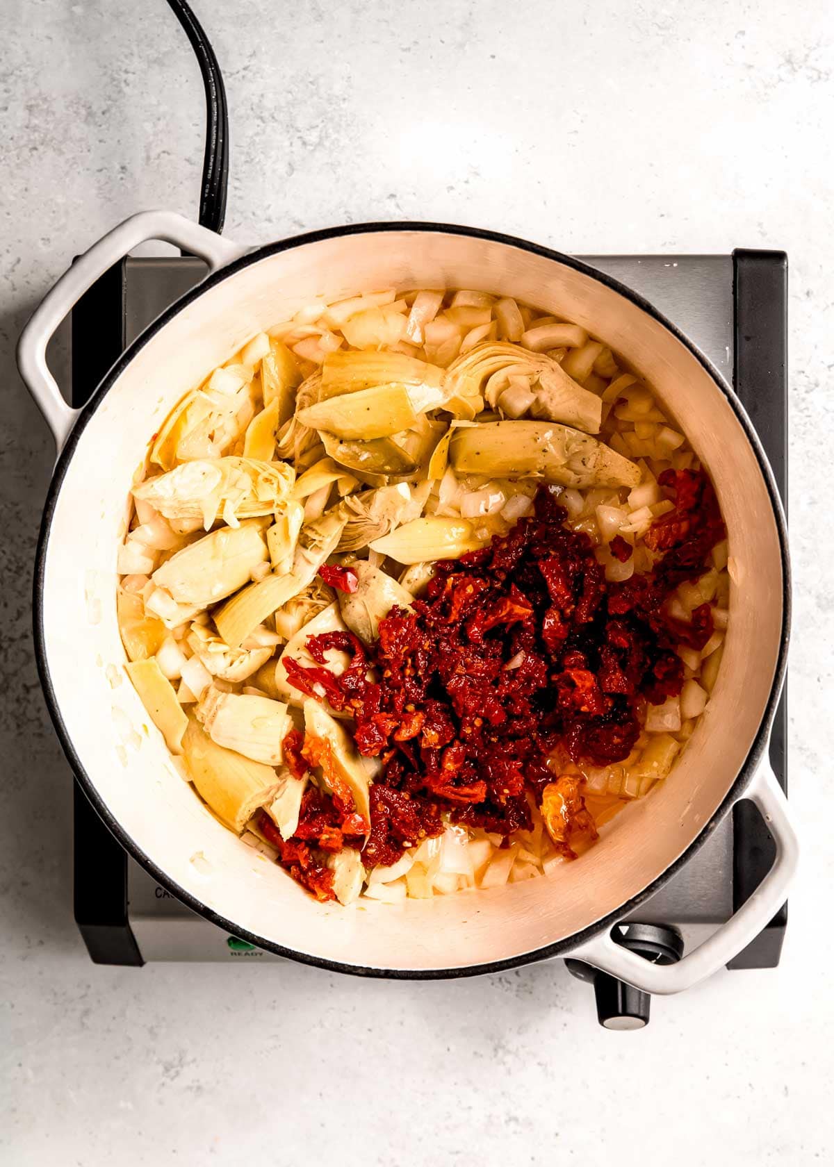 vegetables being added to dutch oven