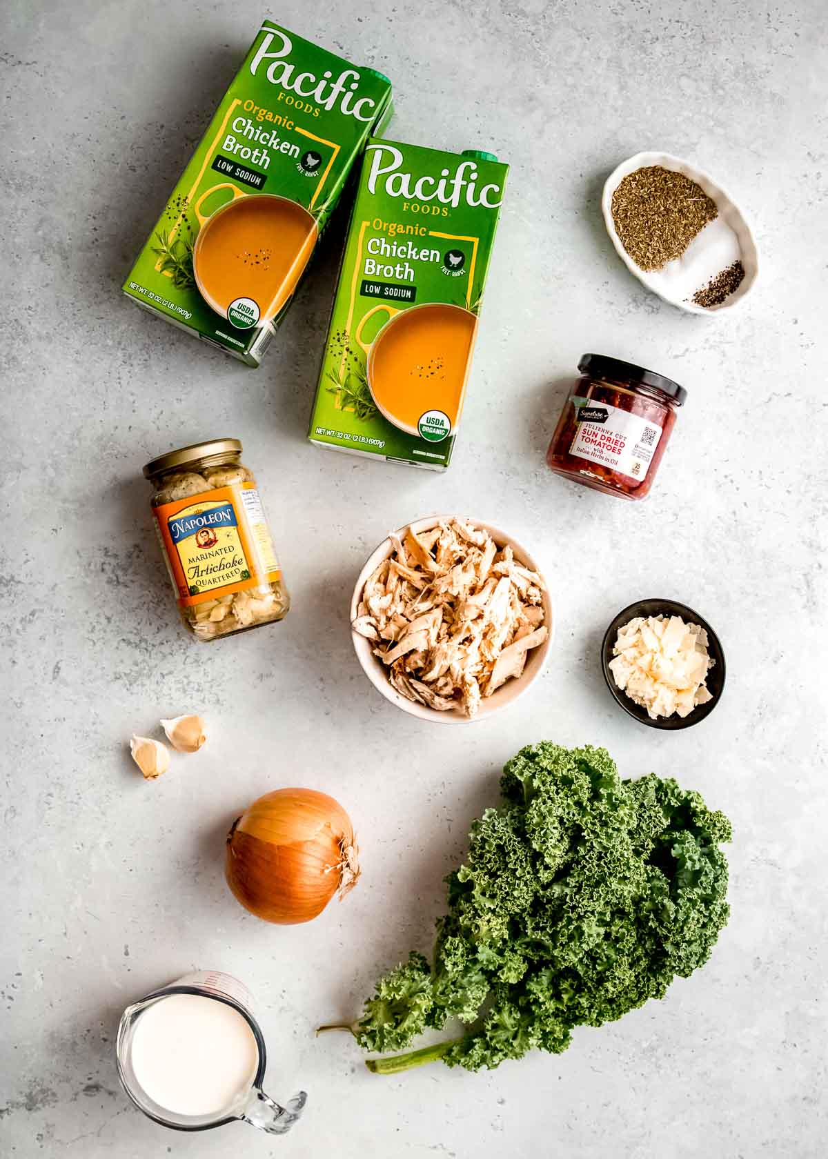 tuscan chicken soup ingredients on a white table