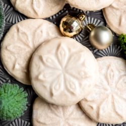 stamped gluten-free cookies on a table with jingle bells