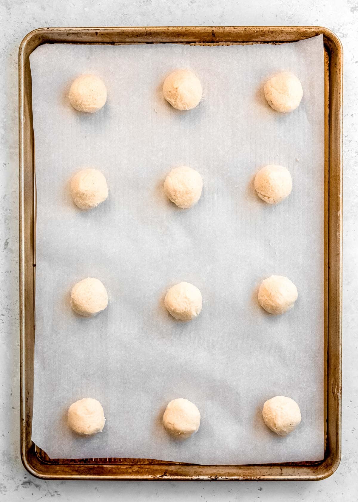 cookie dough rolled into 12 balls, 3 inches apart