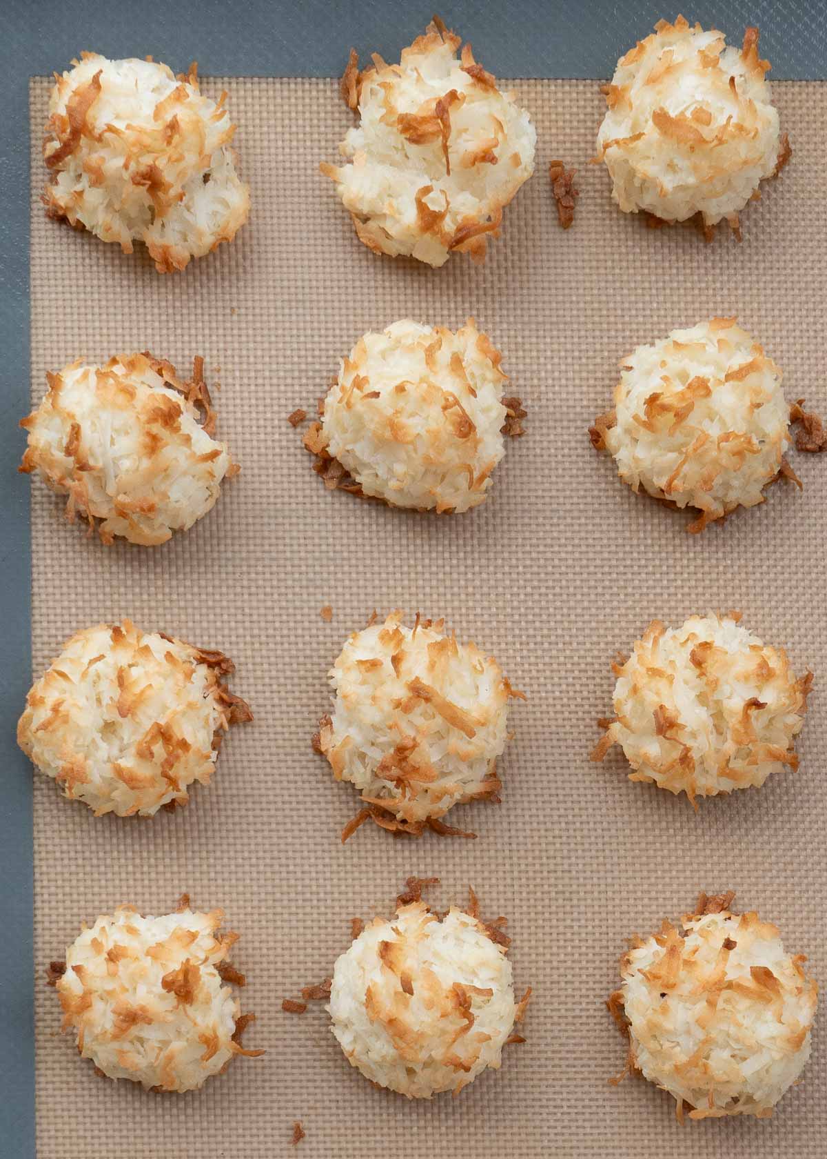 overhead shot of cooked macaroons on baking sheet