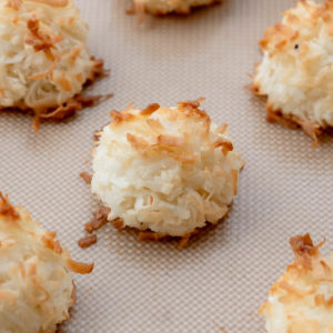 close up of coconut macaroons on cookie sheet