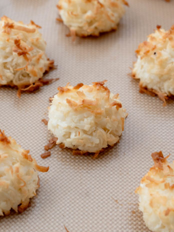 close up of coconut macaroons on cookie sheet