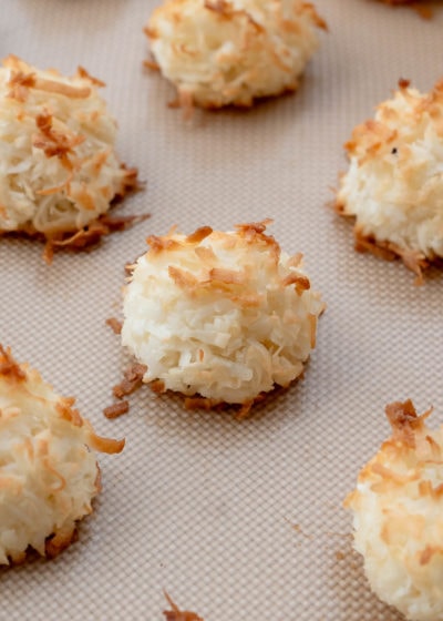 close up of coconut macaroons on cookie sheet