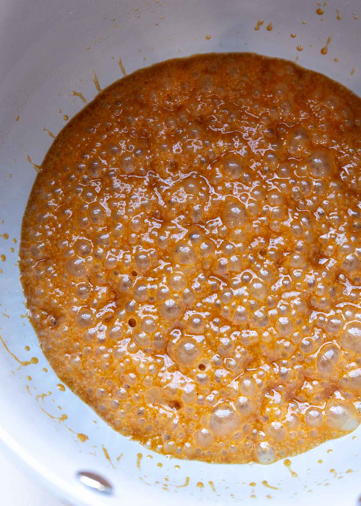 a saucepan of bubbly caramel 