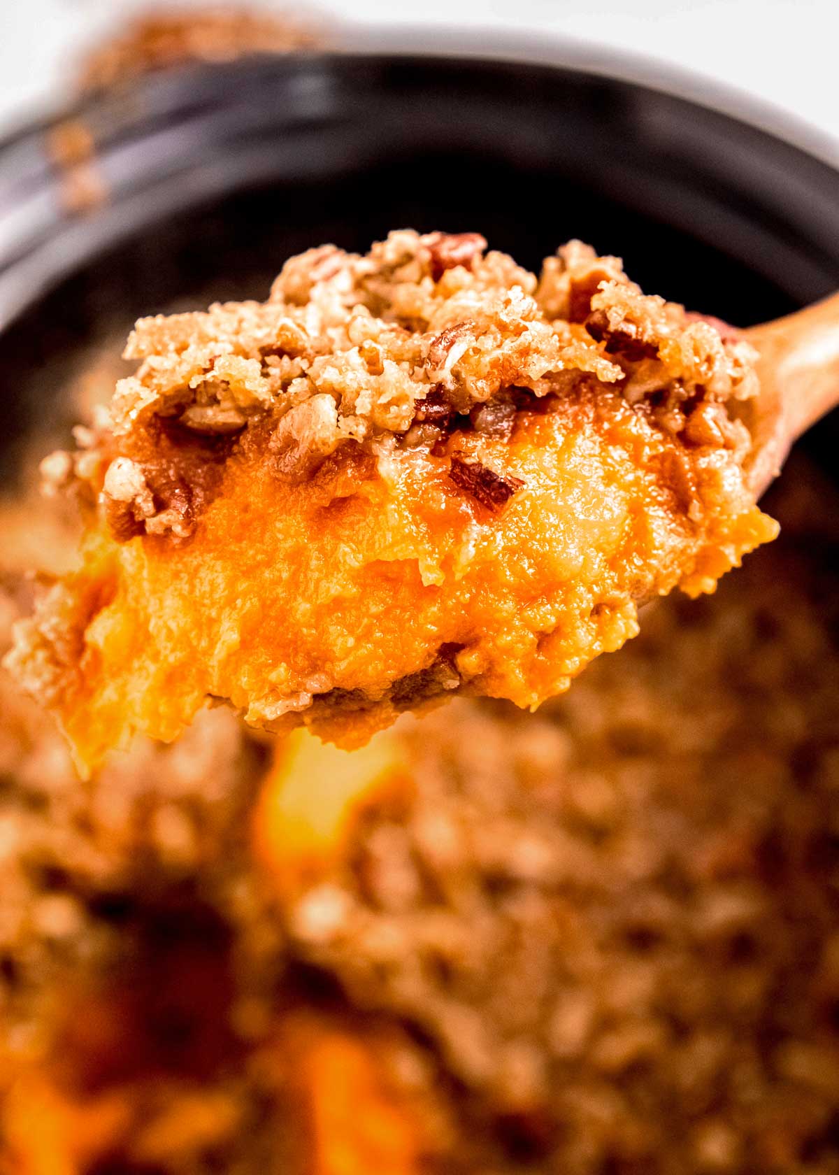 very close up of a spoon of sweet potato casserole