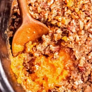 sweet potato casserole in slow cooker with a spoon